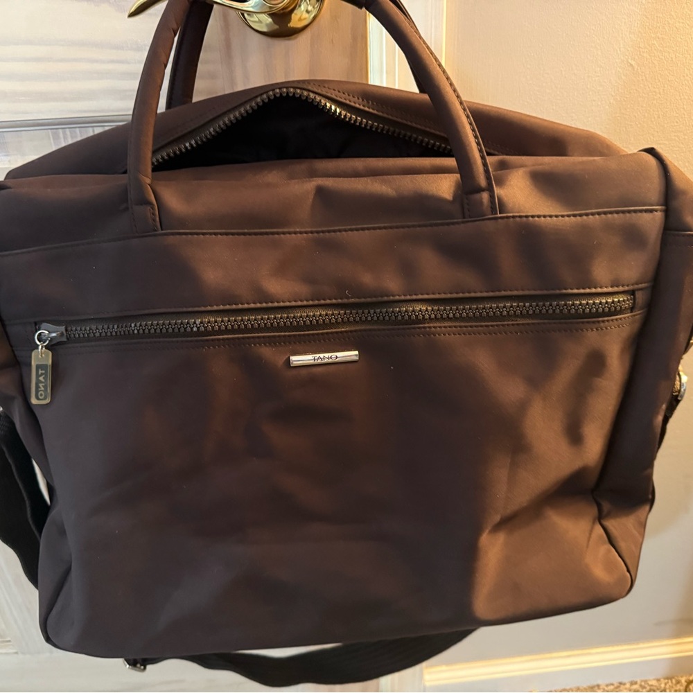 Brown Handbag with Silver Accents. Used for overnights and work bag.